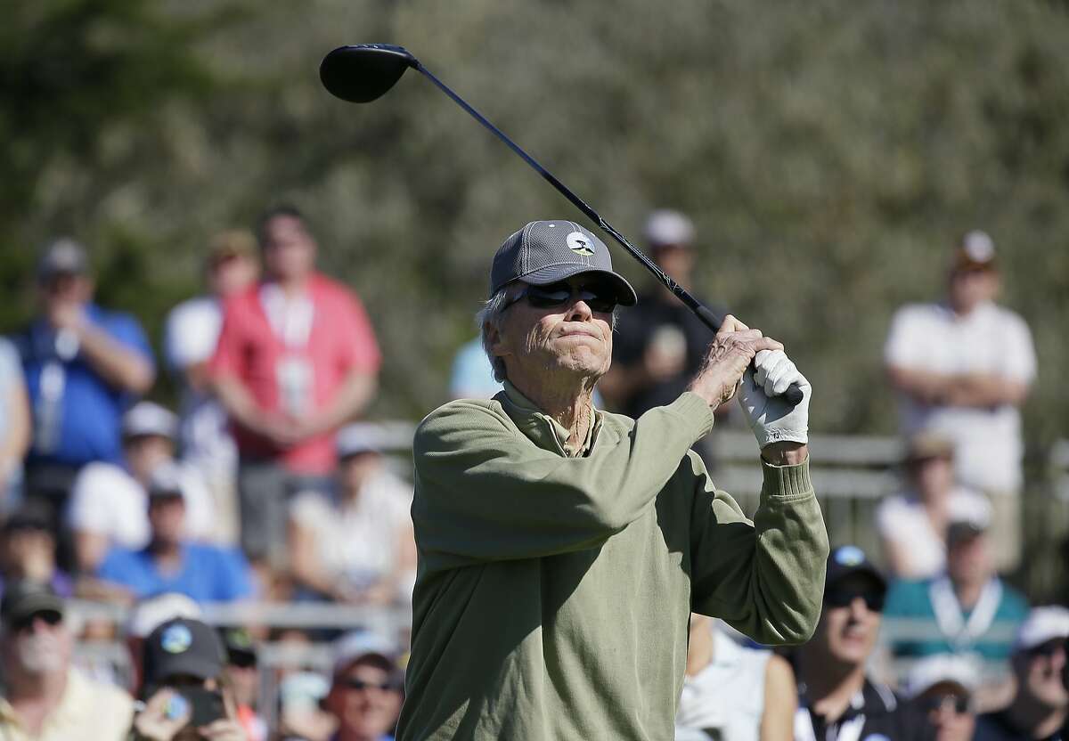 Clint Eastwood follows his shot from the 17th tee during the celebrity challenge event of the AT&T Pebble Beach National Pro-Am golf tournament Wednesday, Feb. 7, 2018, in Pebble Beach, Calif. (AP Photo/Eric Risberg)