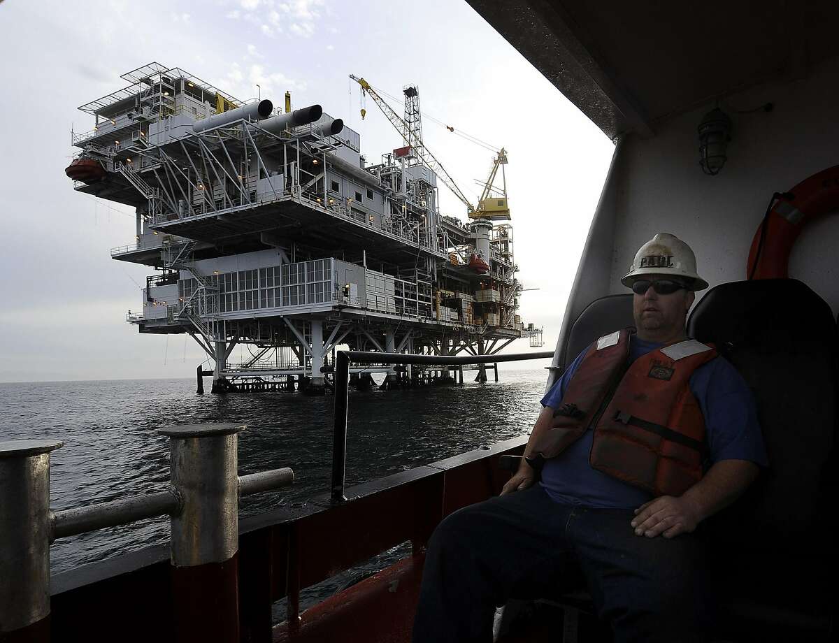 FILE - This May 1, 2009 file photo shows a crew member arriving by boat at offshore oil drilling platform 'Gail' operated by Venoco, Inc. off the coast of California near Santa Barbara, Calif. A revised agreement between several conservation groups and an oil company that wants to expand drilling off the coast of California's scenic Santa Barbara County has been released. The Environmental Defense Center said Wednesday April 7, 2010 that the revision addresses concerns that sidetracked the original 2008 plan, principally by making the agreement public and by giving the state the right to enforce it. (AP Photo/Chris Carlson, File)