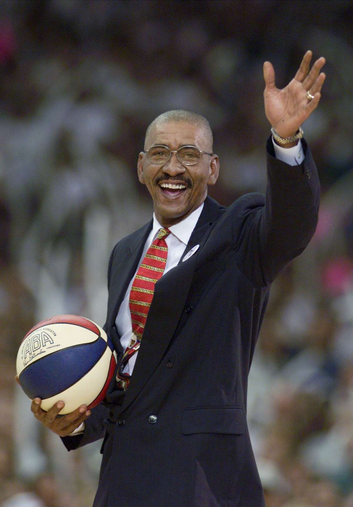 George Gervin waves to fans in the crowd before game one of the NBA Finals June 16, 1999, at the Alamodome.