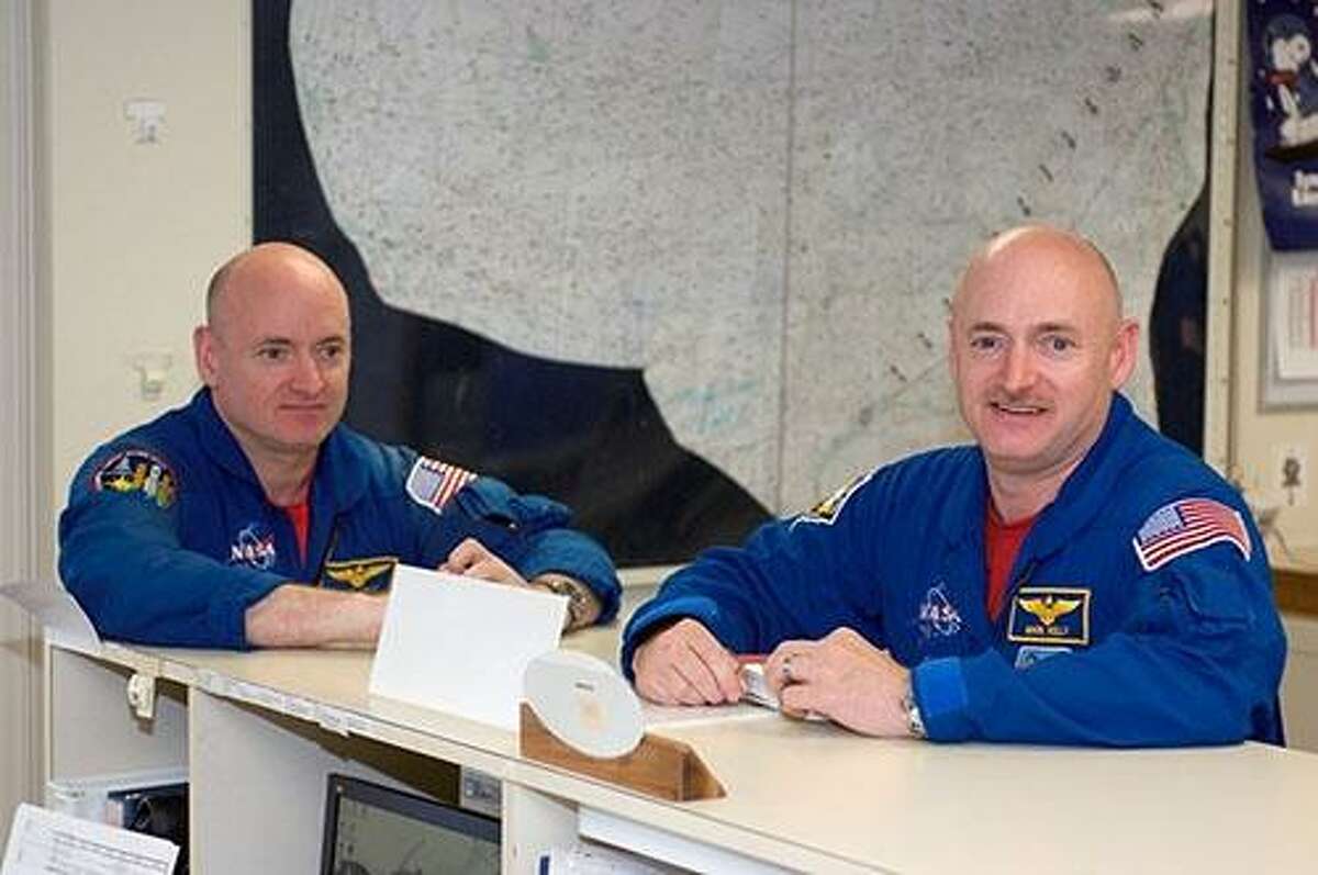 Astronauts Mark Kelly (right and Scott Kelly are pictured in the check-out facility at Ellington Field near NASA’s Johnson Space Center. During Scott Kelly’s time on the space station, NASA tracked both brothers’ vitals and body changes.