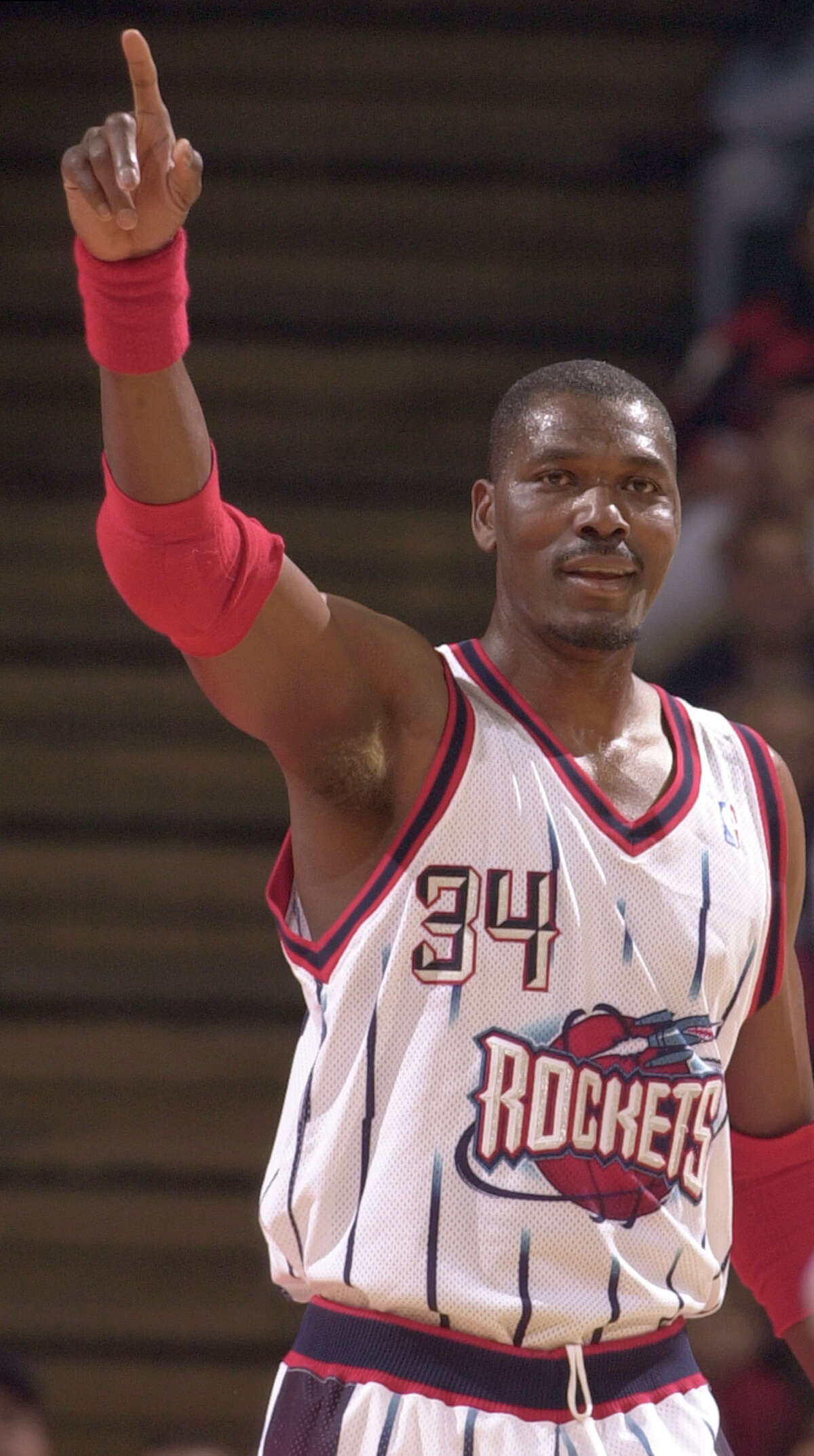 Hakeem Olajuwon celebrates after he started a fast break that ended in a Steve Francis slam during the first quarter of the Houston Rockets season finale vs. the Minnesota Timberwolves at Compaq Center in Houston, TX Tuesday night April 17, 2001. (Smiley N. Pool/Houston Chronicle) 04/17/01. HOUCHRON CAPTION (04/19/2001): A top priority for the Rockets during the off-season is setting the status of Hakeem Olajuwon, who hopes to play another season, with Houston as his preferred locale. HOUCHRON CAPTION (08/02/2001): Hakeem Olajuwon led the Rockets to two NBA championships. HOUCHRON CAPTION (08/04/2001): Houston has had many sports icons, and coincidentally, some of the best have worn the number 34: Earl Campbell (NOT PICTURED). Nolan Ryan (NOT PICTURED). Hakeem Olajuwon. In Sports 2, the Chronicle relives Olajuwon's stellar career and lists his 34 greatest moments as a Rocket. HOUCHRON CAPTION (08/05/2001): On the cover: Hakeem Olajuwon photographed by the Chronicle's Smiley N. Pool during his final game in a Rockets uniform on April 17, 2001. HOUSTON CHRONICLE SPECIAL SECTION: HAKEEM OLAJUWON: SPACE CITY DREAM.