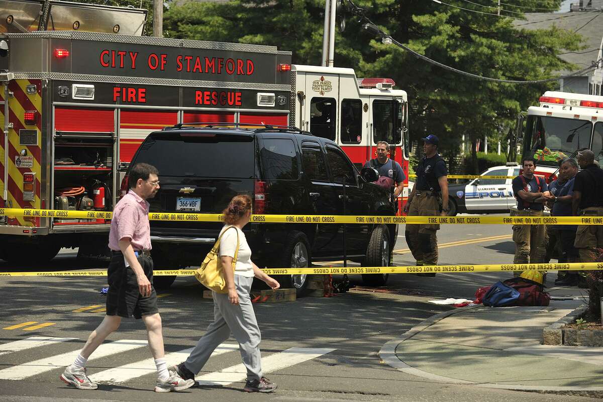 FILE — Pedestrians cross Hoyt Street watching emergency personnel at the scene where Janice Pielert was struck and killed by an SUV.