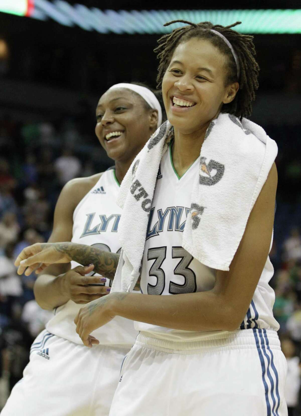 Minnesota Lynx forward Monica Wright (22) shares a laugh with teammate guard Seimone Augustus (33) in the second half of a WNBA basketball game against the Chicago Sky, Thursday, Sept. 8, 2011, in Minneapolis. Augustus lead with 22 points in the Lynx's 78-69 victory. (AP Photo/Stacy Bengs)