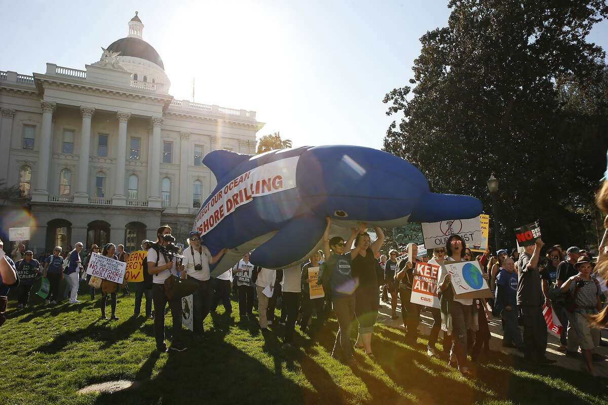 Hundreds of protesters march after a rally at the California State Capitol, Thursday, Feb. 8, 2018, in Sacramento, Calif. Hundreds of people protested against offshore oil drilling.