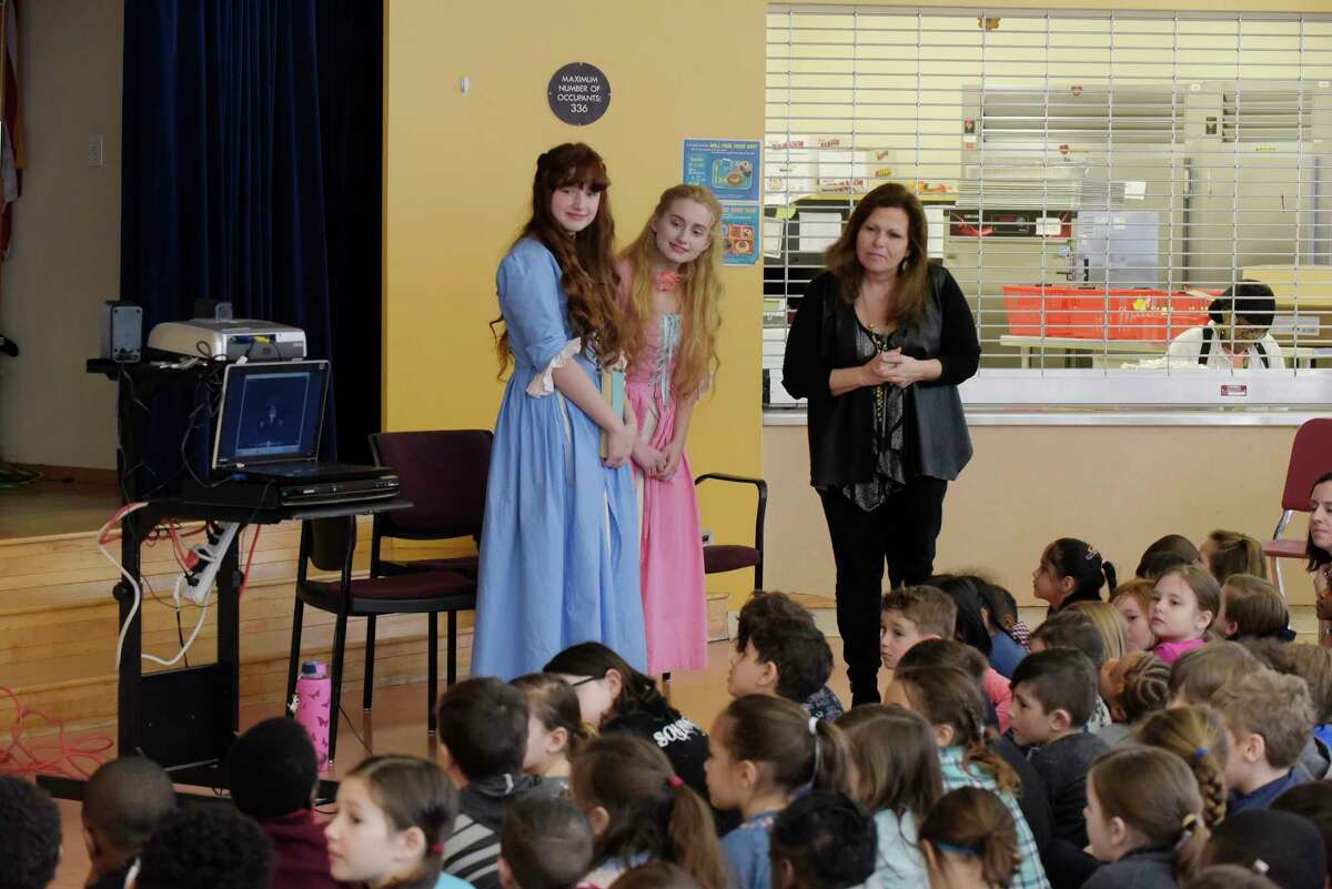 Sisters, Demetra, left, 15, and Callista, center, 17, Zorbas from Colonie, dressed as their characters from the television show, The Adventures of Snow White and Rose Red, and Ann Marie Lizzi, one of the producers, directors and editor of the series, talk with students at the Montessori Magnet School on Thursday, Feb. 8, 2018, in Albany, N.Y. Lizzi, has two children at the school and held an event to show the children how a television show is created. The show used all local actors and was filmed this past summer in and around the Saratoga Springs area. The series will be distributed through Amazon Prime sometime in the spring or early summer. A trailer for the show can be viewed on Prime. This Saturday there will be a screening of selected episodes from 10:00am to 4:00pm at the National Museum of Dance. Tickets for the screening can be purchased through www.eventbrite.com (Paul Buckowski/Times Union)