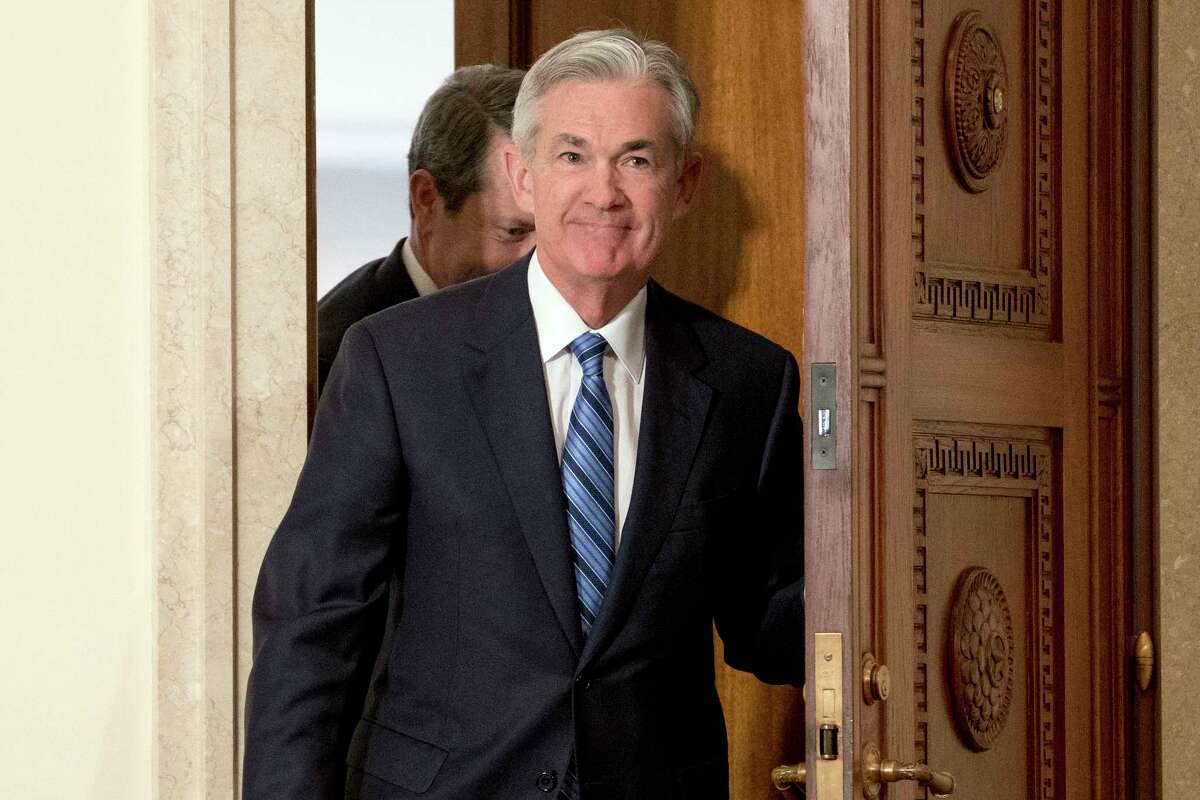 FILE- In this Monday, Feb. 5, 2018, file photo, Jerome Powell arrives to take the oath of office as Federal Reserve Board chair at the Federal Reserve in Washington. On Monday the Dow Jones industrial average endured its worst percentage drop since 2011. The market turbulence had been set off by fears that higher inflation would lead the Fed to accelerate its interest rates hikes and weaken the economy and the stock market. The worry among investors is just one of the issues Powell faces as he succeeds Janet Yellen. (AP Photo/Andrew Harnik, File)
