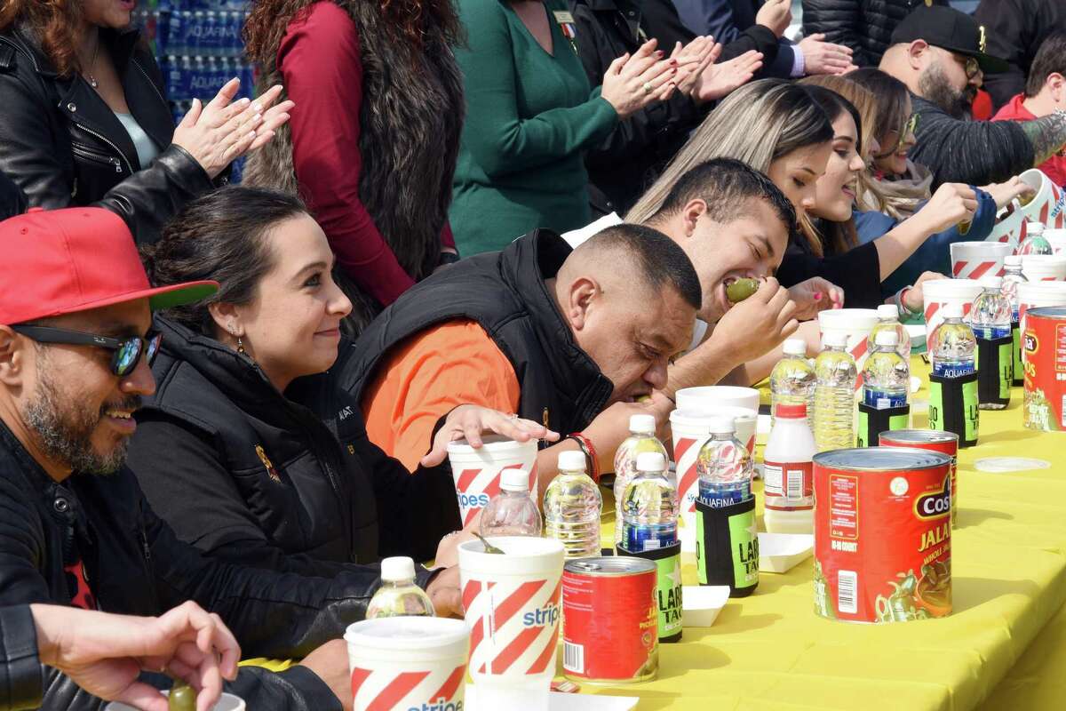Contestants are shown eating spicy peppers during the Stripes Media/Celebrity Jalapeño Eating Challenge at store 2519, off Jacaman Road on Thursday.