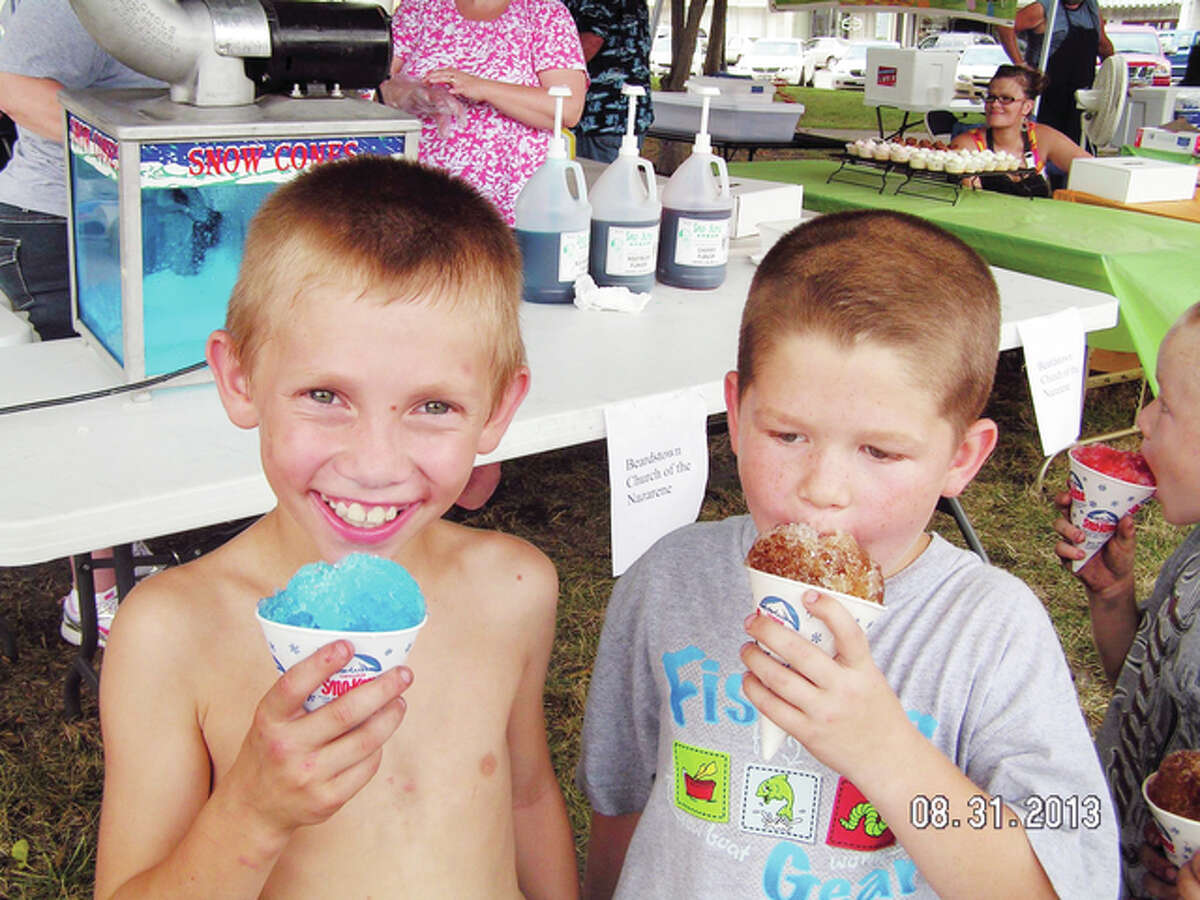 Two boys enjoy snowcones during the 2014 Taste of Beardstown. The event offers a chance to sample foods from a variety of restaurants and organizations in the area.