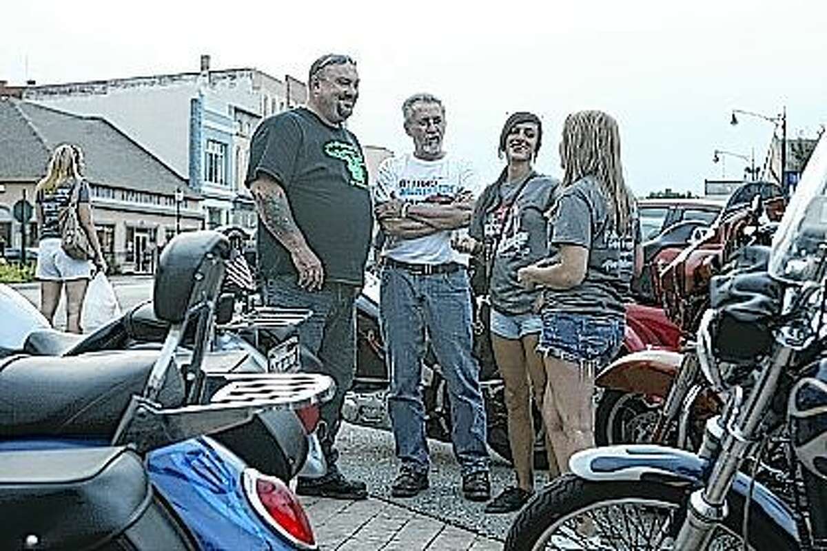 About 90 motorcycles and some 50 cars and trucks participated in the second annual Leo Alfano and Morgan McKinnon All-Vehicle Memorial Independent Run Saturday. The event began at 2 p.m. at On the Rox in downtown Jacksonville and participants made stops in Woodson, Roodhouse, Winchester and Naples before returning to On the Rox. The fundraiser, which was held in memory of Alfano and McKinnon, who died of injuries suffered in a motorcycle accident in July 2013, benefited ABATE, an organization dedicated to motorcycle safety and awareness. Chris Norton, president of Tri-County ABATE (left), speaks with Bob Stambaugh, public relations officer of Tri-County ABATE, Filippa Alfano, sister of Leo Alfano, and Erica Johnson, sister of Morgan McKinnon, after the event.