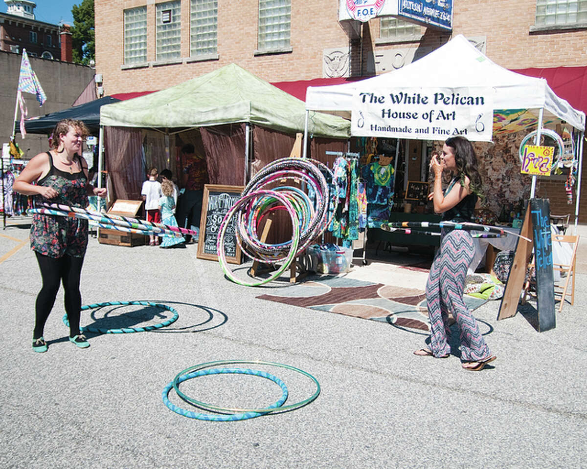 Sarah Carney, left, and Samantha Ansell test out some of the hoola-hoops that Carney made and makes available at the White Pelican House of Art in Grafton.