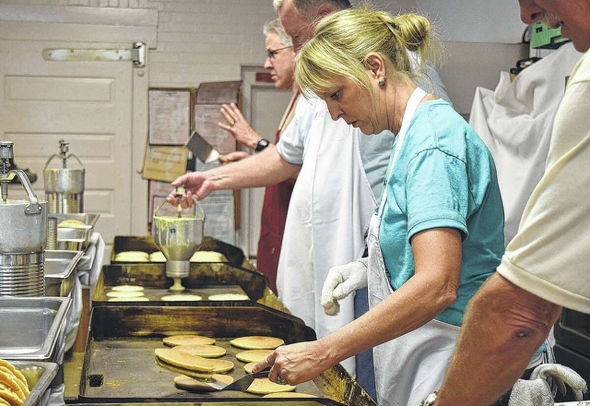 Kiwanis Pancake and Sausage Day co-chair Lisa Galloway flips pancakes on the grill.