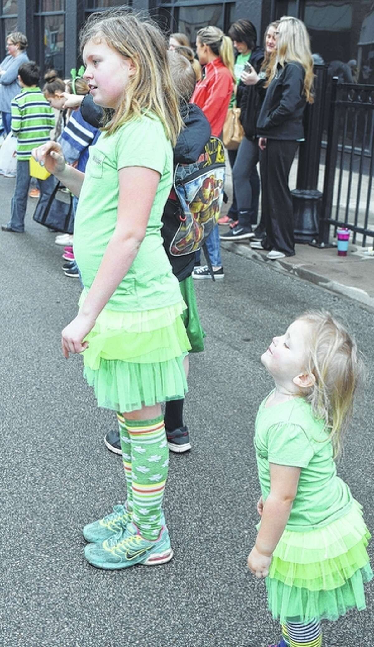 Samantha Flynn, 10, and Rochelle Williams, 2, daughters of Amy Harms, all of Jacksonville, wait Saturday morning for the start of the Jacksonville St. Patrick’s Day Parade.