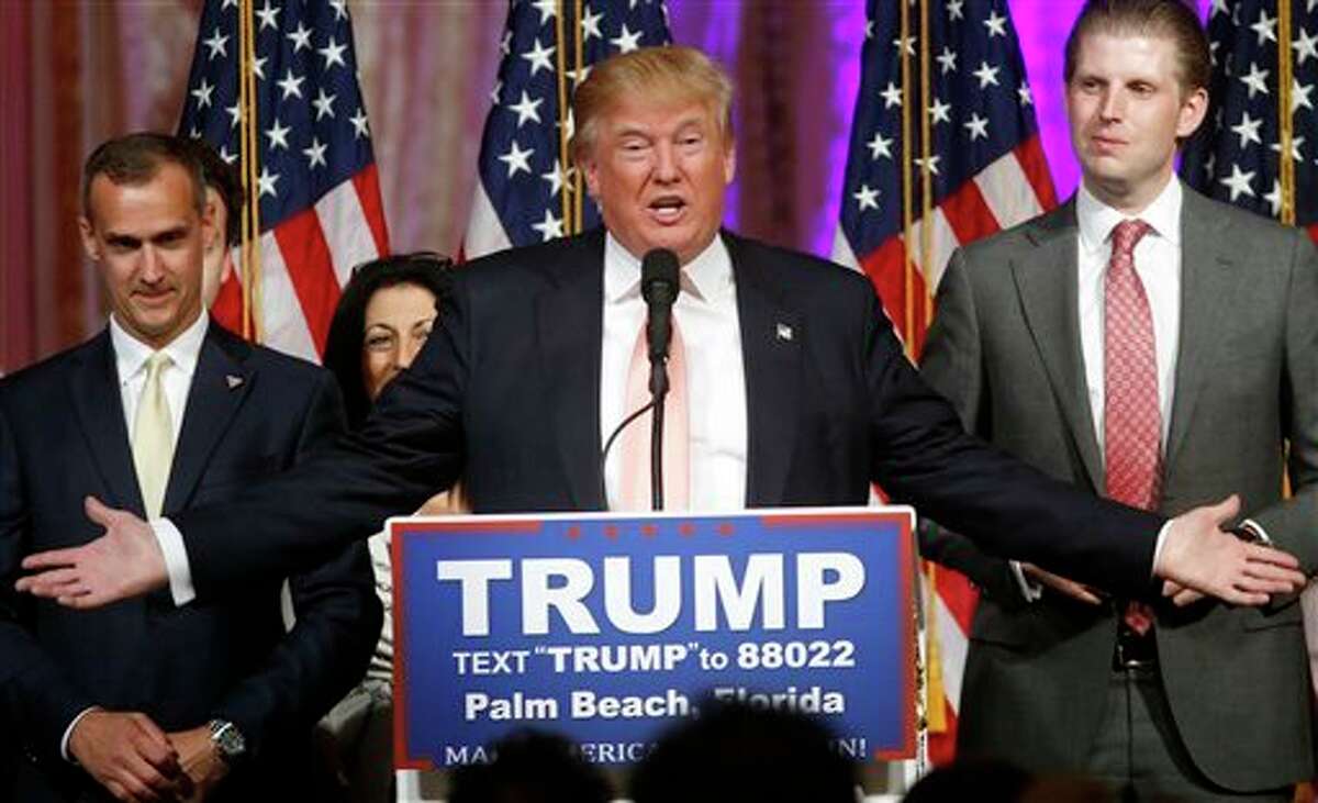 Republican presidential candidate Donald Trump speaks to supporters at his primary election night event at his Mar-a-Lago Club in Palm Beach, Fla., Tuesday. At right is his son Eric Trump and at left is campaign manager Corey Lewandowski. AP Photo | Gerald Herbert