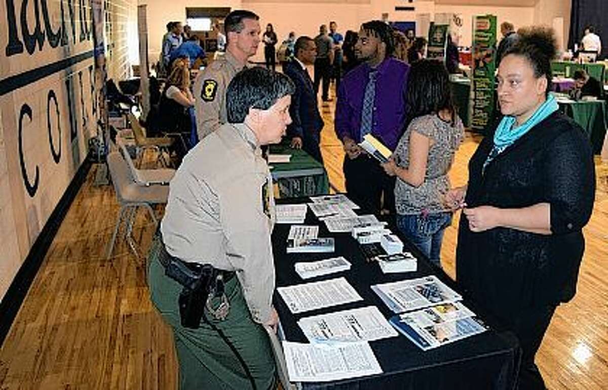 Illinois State Police Sgt. Linda Strubbe (left) talks Wednesday with MacMurray College junior Jasmine White of Jacksonville at the Jacksonville College and Community Career Fair at MacMurray. Nearly 50 businesses and three graduate schools provided information on internships and full-time jobs. The businesses represented such fields as health care, accounting, news media, hotel management and manufacturing. The career fair was co-sponsored by MacMurray College and Illinois College.