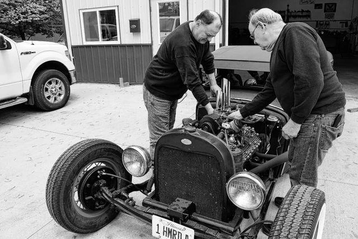 Rick Northrop (left) and his father, Terry Northrop, owner and operator of Terry Northrop Garage at 836 Hardin Ave., work Thursday on a 1951 Mercury engine in a chopped 1931 Ford Model A pickup truck owned by Roger Yeager of Pittsfield.