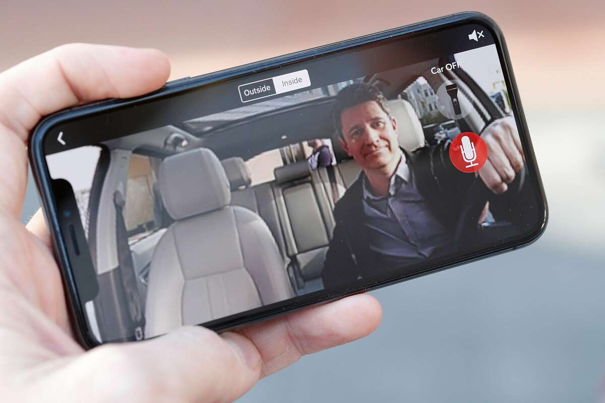 Owl Cam CEO Andy Hodge visible on a smart phone displaying the video feed of an Owl car security cam mounted in a company vehicle at their headquarters in Palo Alto, Calif., on Thursday, February 8, 2018. Palo Alto startup Owl has created a car security camera, placed on the dashboard, with cameras facing forward and backward, to automatically record any incident involving the car. This includes break-ins, crashes, parking lot dings.