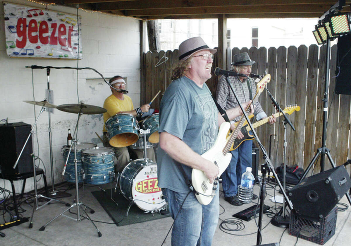 Jacksonville-area band Geezer performs recently at Lahey’s Lounge in downtown Jacksonville. Members are Gary Donohoo (from left), Roy Mathy and Stan Robinson. Geezer will release its first compact disc — “Rockin’, Rollin’ and Strollin’ — at 8 p.m. Friday at Don’s Place, 207 W. Morgan St.