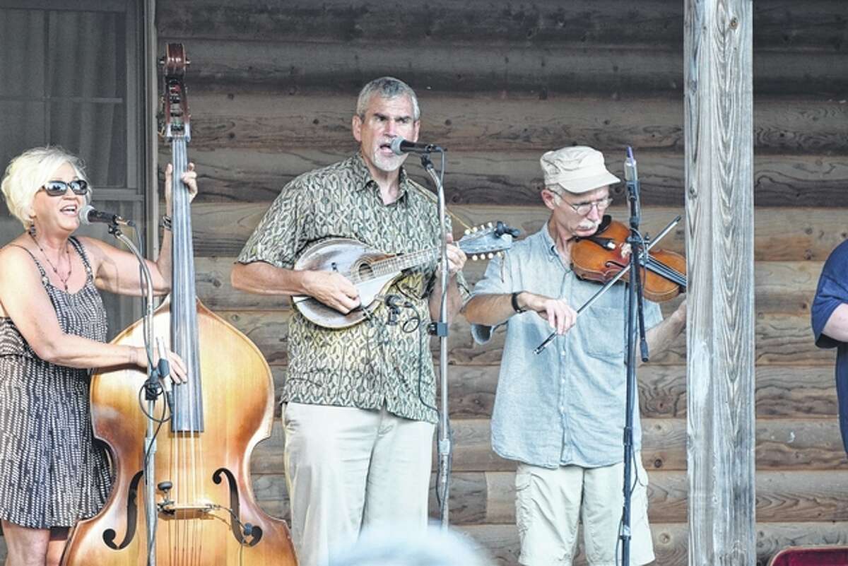 Burr Oak String Band members Ava Bova (left), Mark Mathewson, and Steve Staley perform Friday at the Ninth Annual Crazy Horse Bluegrass Festival. Performances from other bands will continue today starting at 1 p.m.