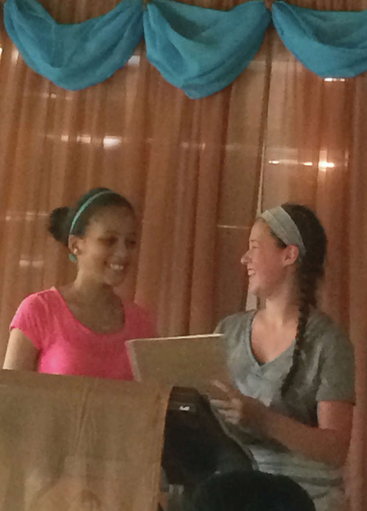 A Dominican translator listens to testimony from Abi Swift (right) of Jacksonville during a mission trip to the Dominican Republic.