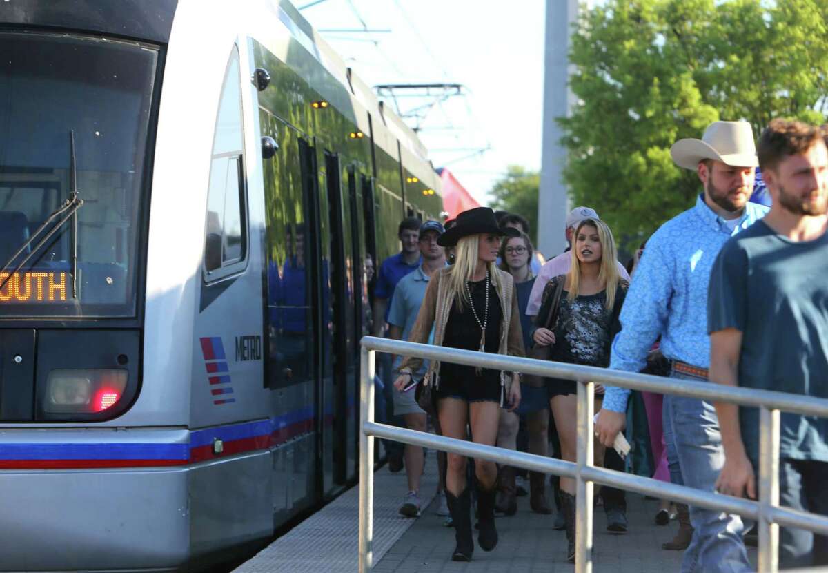 Visitors to the the Houston Livestock Show and Rodeo disembark the Metro light rail train along Fannin Street, Tuesday, March 21, 2017.
