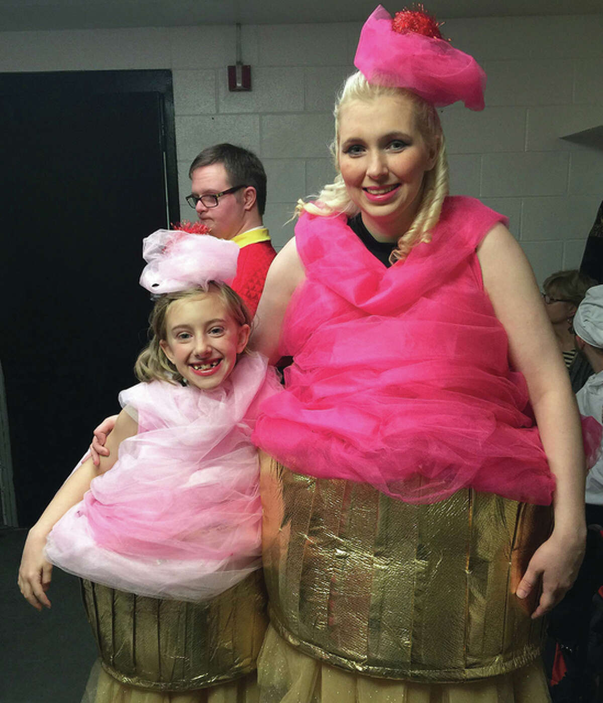 Erin Hart (right) and her mentor, Isabelle Stanton, dress as enchanted cupcakes during a practice for the Chicagoland Ice Theatre Inspirations team performance of “Beauty and the Beast.”