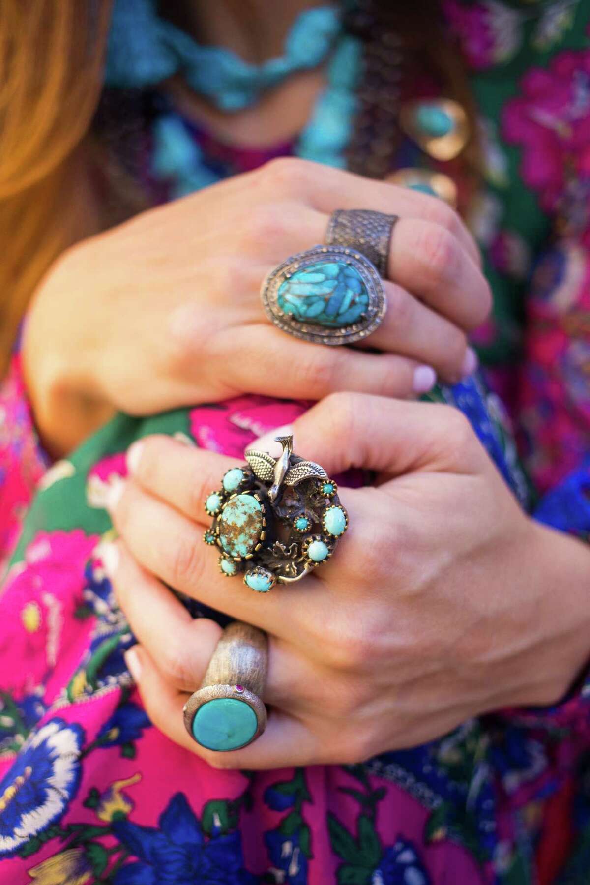 RODEO FASHION: Dress from Anthropologie - $228. Squash blossom necklace - $1,800, Seeping Beauty turquoise necklaces (sheÂ?’s wearing two of the same necklace) - $300 each,Â  Turquoise tassel earrings - $35,Â Â  RINGS (from top to bottom in photo)Â  Champagne diamond cigar band - $600, Turquoise ring with diamond surround - $375, Turquoise ring with sterling silver bird - $342, andÂ  Turquoise and sterling silver ring - $225. All from J. Landa in Rice Village