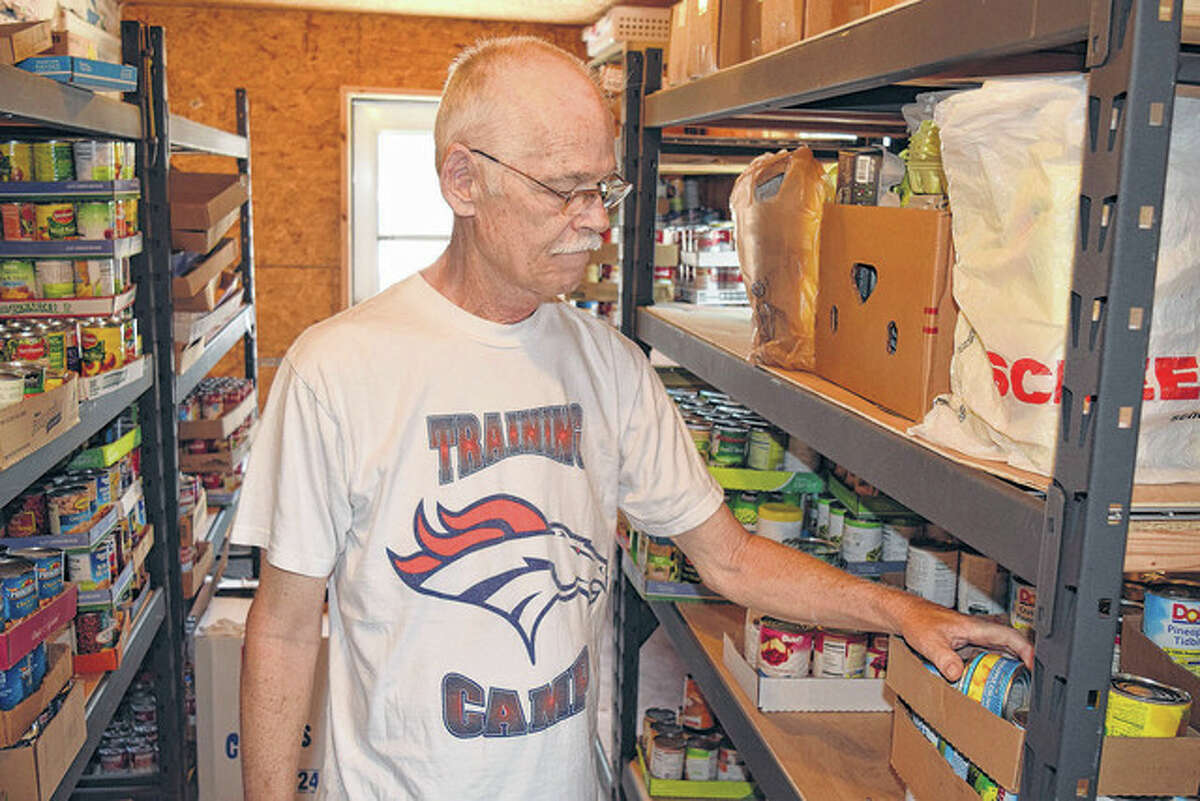 Gale Custer looks over items on the shelves of the North Greene Food Pantry.