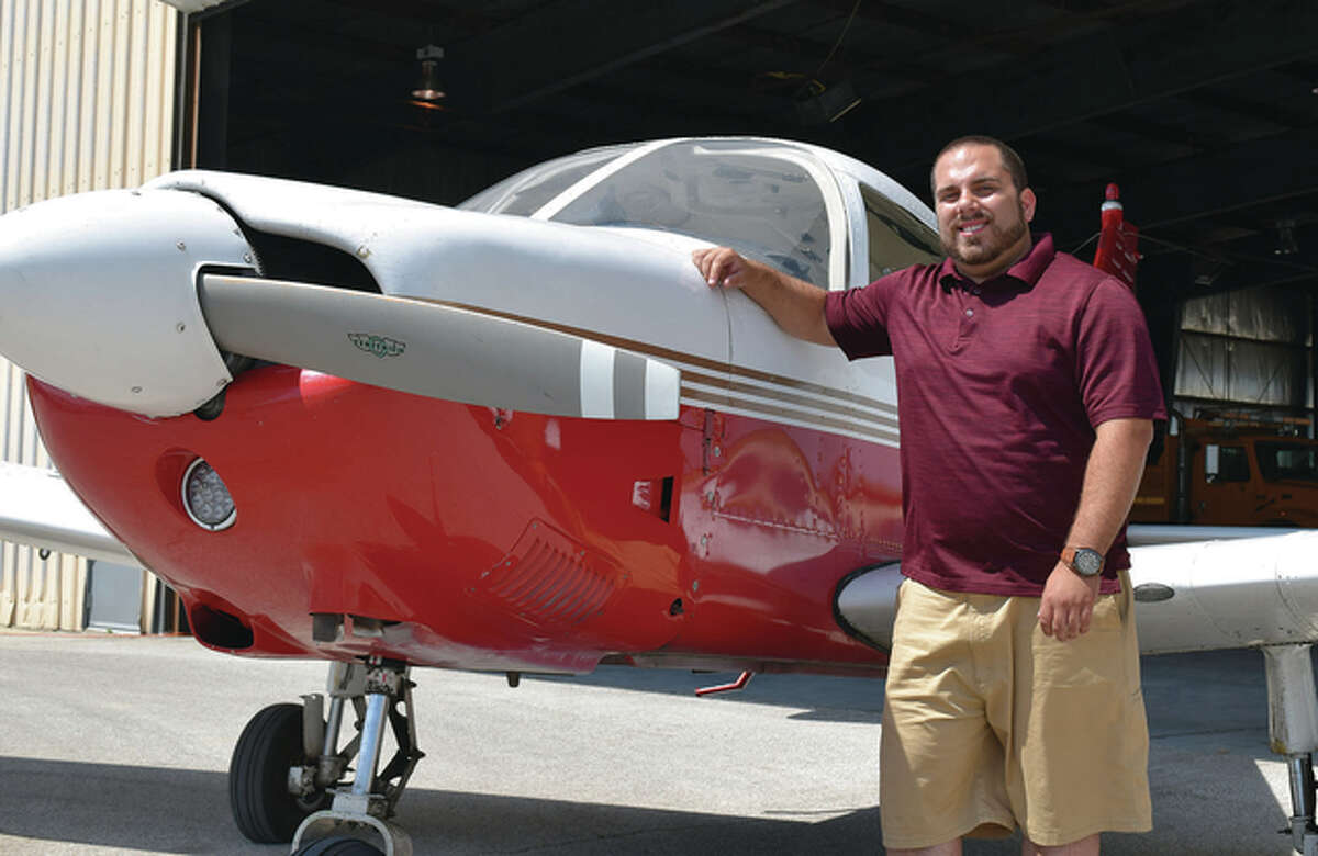 Jacksonville Municipal Airport’s new flight instructor, Brandon Montrey, stands next to a Piper Archer single-engine plane at the airport.