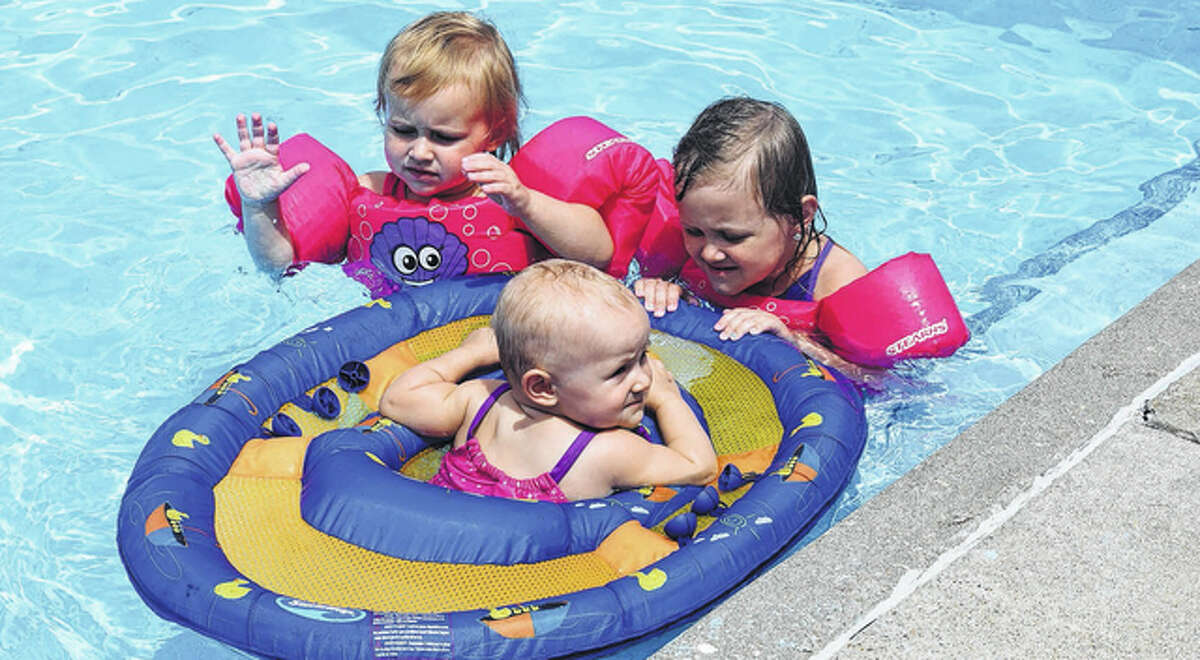 Dozens of swimmers cooled off Friday in Nichols Park Pool, escaping the heat and humidity that has settled over west-central Illinois the past few days. Among the swimmers were these three sisters — Raelyn Brantley (left), 2, Madelyn Brantley, 4, and Eliana Brantley, 11 months. They are the daughters of Teri and Michael Brantley of Jacksonville.