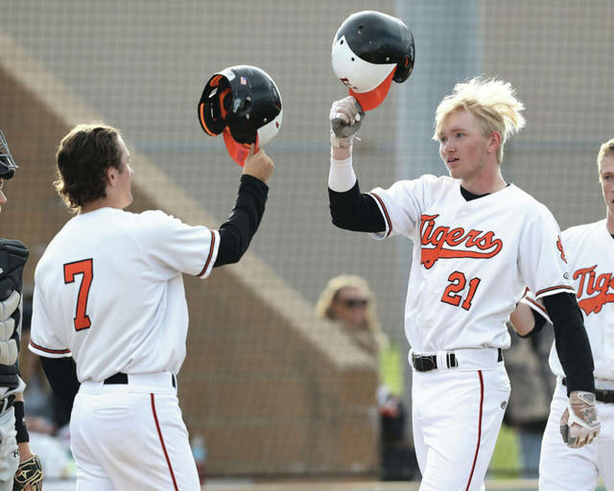 Edwardsville’s Andrew Yancik (21) celebrates with Kade Burns (7) after Yancik hit a three-run homer during a win over Alton in an Edwardsville Class 4A Regional semifinal at Tom Pile Field on May 24 in Edwardsville. Yancik and Burns are the scheduled starting pitchers for the Tigers’ state tourney games Friday and Saturday in Joliet.