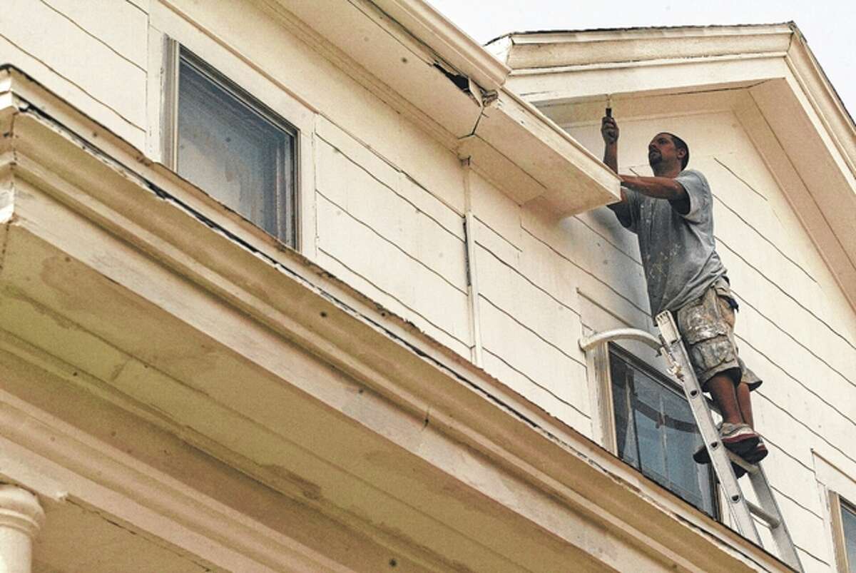 Michael Bertram, an employee of Midwest Power Wash and Paint, works on the east side of the Clay House at 1019 W. State St. in Jacksonville. The historic home is being refreshed with new exterior paint. The house is part of the Underground Railroad tour, but was not used to keep runaway slaves safe. Instead, two slaves escaped from the Clay House after being told by people in town that they were considered free in the North, according to historical accounts.