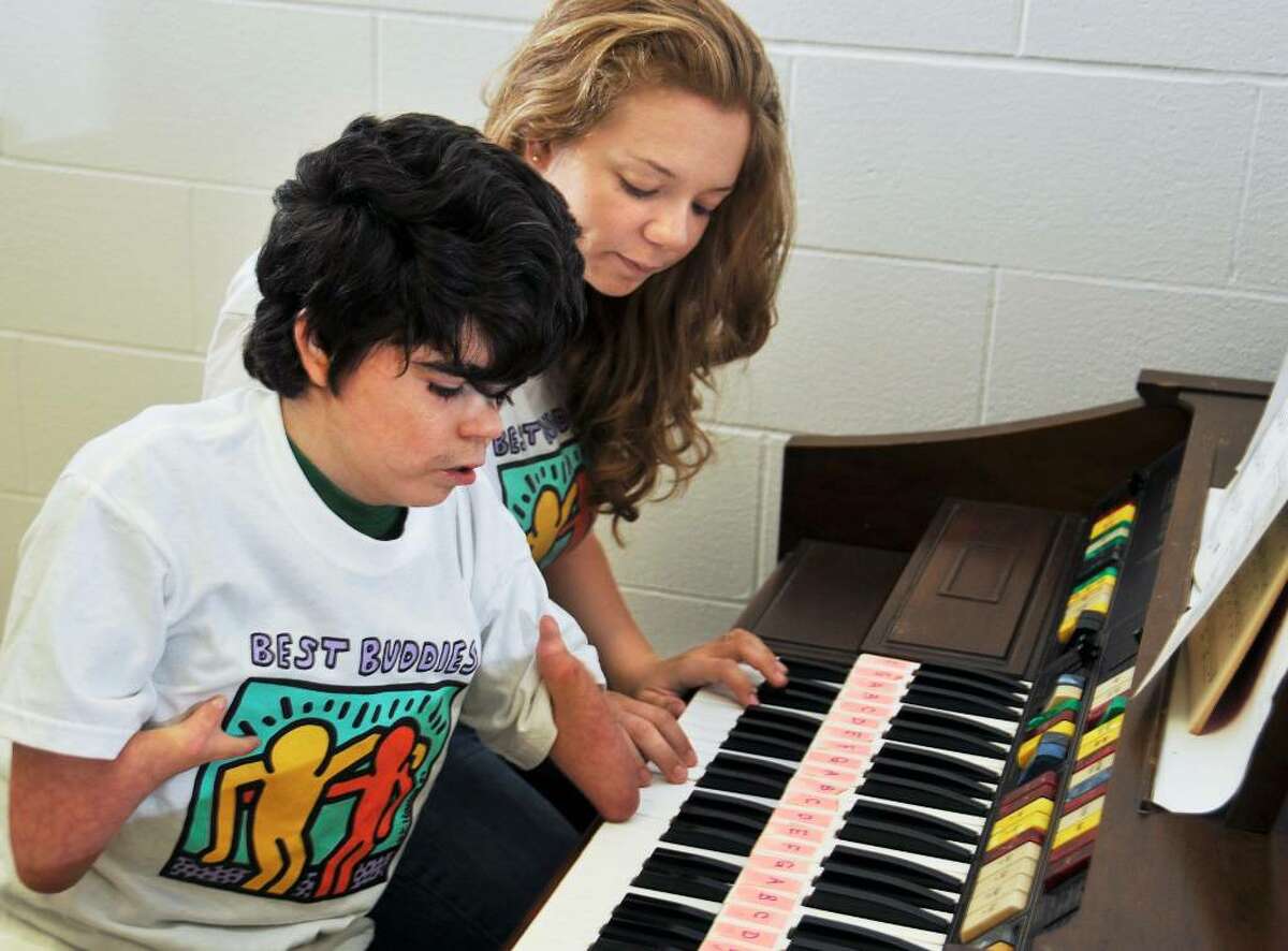 Ballston Spa High School students, Ashlie Busone and Will Smisloff share a keyboard in a music room at the school Tuesday morning. They are members of the Best Buddies program. (John Carl D'Annibale / Times Union)