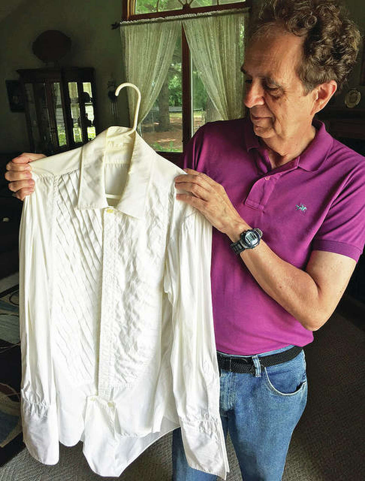 Jim Wiemers holds a tuxedo shirt that he purchased at a used clothing store in California, believed to have once belonged to Frank Sinatra.