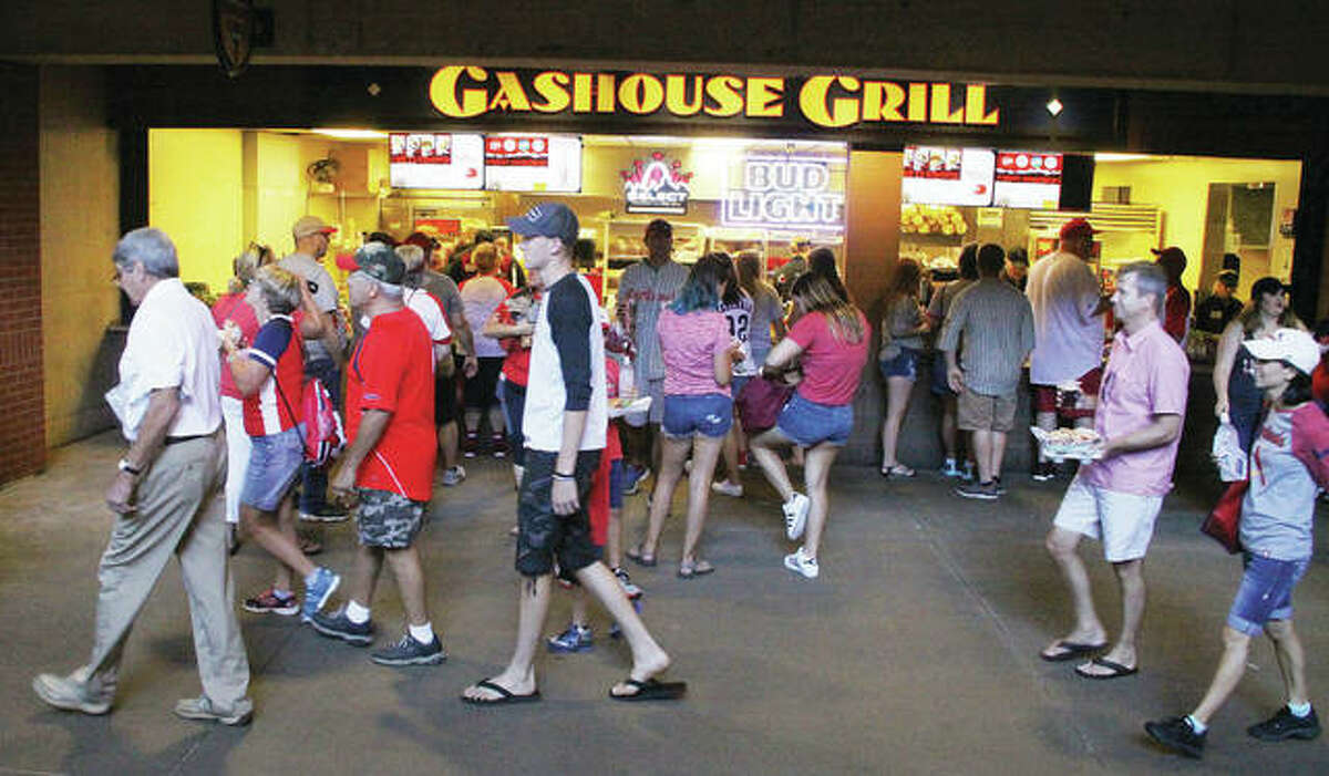 Baseball fans walk by as some get food and drinks at a concession stand at Busch Stadium manned by volunteers from Wood River’s Ivy Heights Church of God and Bethalto’s Lifebrook Church of God.