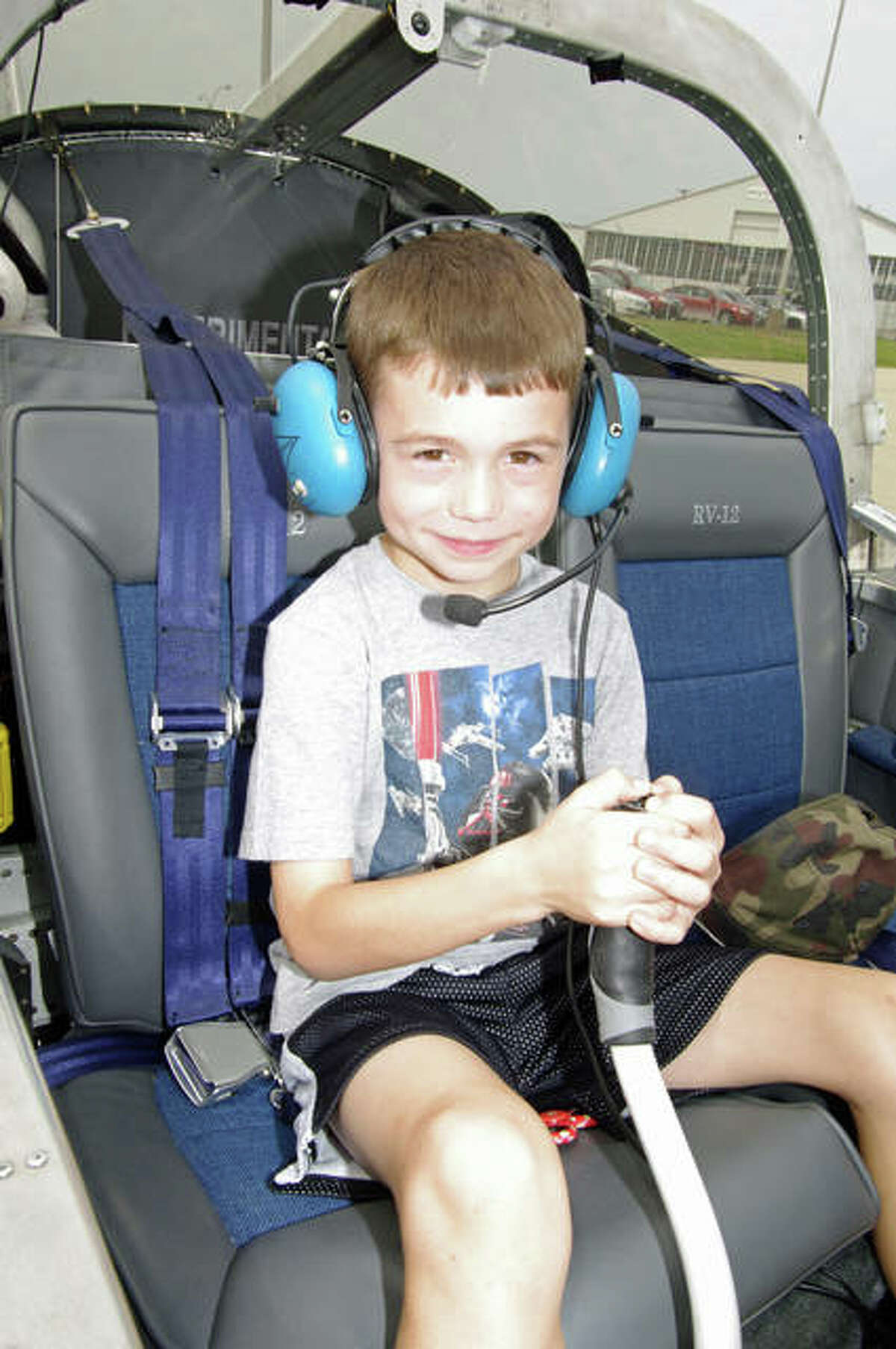 Six-year-old Abram Dabbs of Godfrey tries the control stick inside of an airplane cockpit during Saturday’s Pizza, Planes and Pilots event at St. Louis Regional Airport.