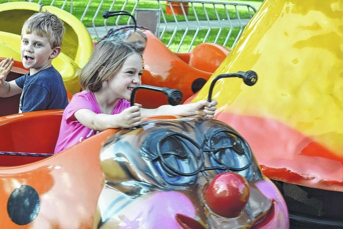 Josie Day, 6, of Dustin and Deanne Day, and William Edwards, 5, of Stephanie Bagley and Steve Edwards, ride a lady bug ride Friday at the Waverly Community Picnic.