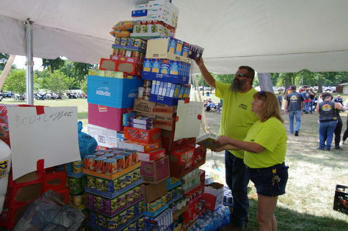 Misfitz group members Marie Murrell and Barry Ingersoll check their club’s Foodstock donations at a past Foodstock event. This year's Foodstock is planned noon to midnight Saturday, Sept. 17, at the Cottage Hills VFW.