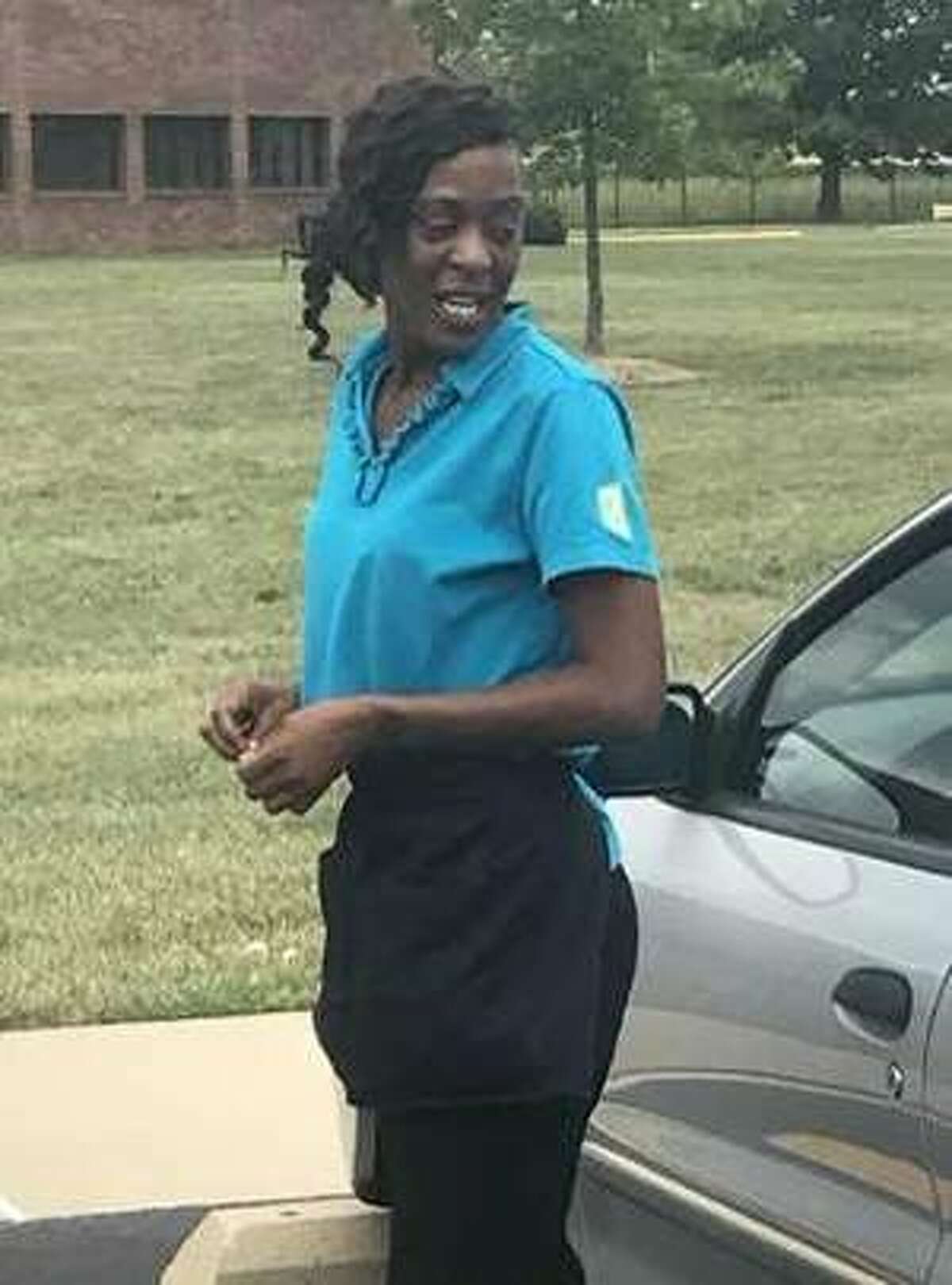 Angel Dotson is seen in front of her 2005 silver Chevy Cavalier.