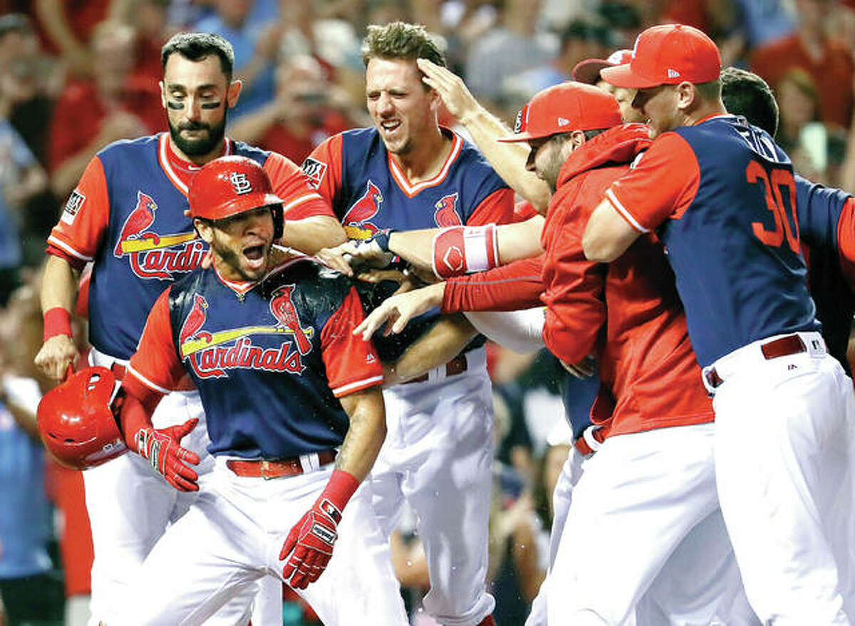The Cardinals’ Tommy Pham, second from left, is is congratulated by teammates after hitting a walk-off two-run home run to defeat the Tampa Bay Rays 6-4 Saturday at Busch Stadium.