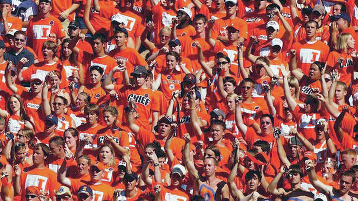 University of Illinois football fans display the ‘Tomahawk Chop’ during the playing of the ‘War Chant’ by the Marching Illini. The school has announced that the song will no longer be played at Illini athletic events.