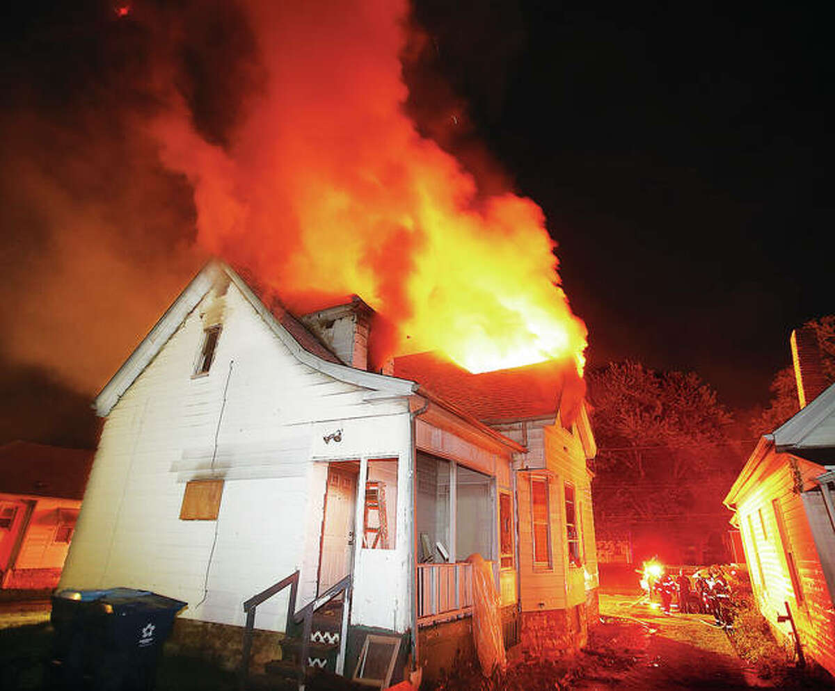 John Badman|The Telegraph As seen from the rear of 931 College Avenue, flames engulf the second floor of the house which was extensively damaged in the blaze that was reported about 12:30 a.m. Monday.