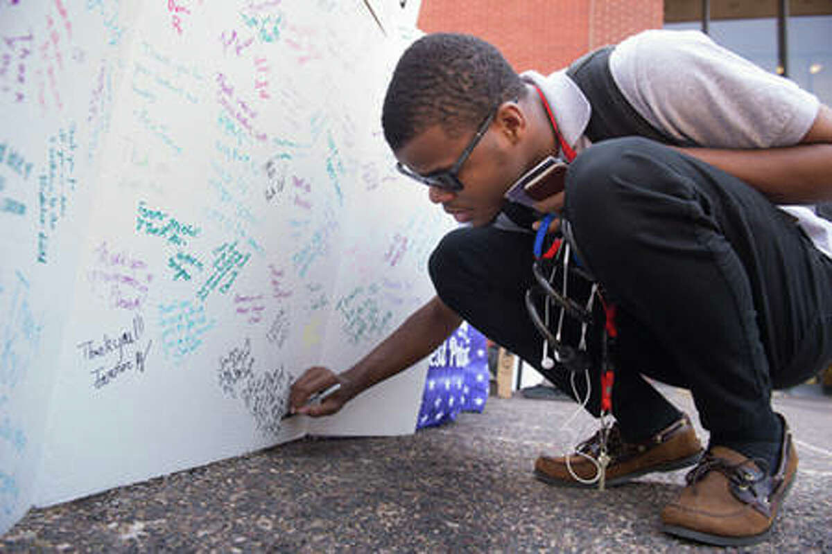 SIUE freshmen Marcus Key pens his thoughts on a 9/11 tribute card.
