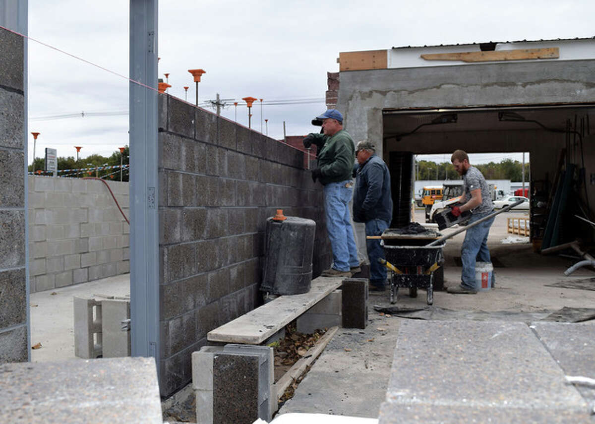 Bricklayers from Lotz Masonry of Jacksonville place concrete blocks Wednesday for Baywash’s new automatic car washing units on West Morton Avenue. The 30-year-old car wash is being remodeled and should reopen by the end of the year, according to its owners.