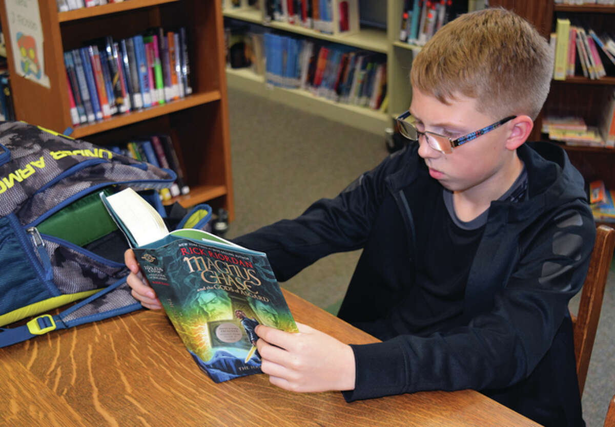 Tyler Headen, the 12-year-old son of Katie and Jamie Headen of Jacksonville, reads “The Hammer of Thor” at the Jacksonville Public Library on Wednesday. The book is part of author Rick Riordan’s series titled “Magnus Chase and the Gods of Asgard.”