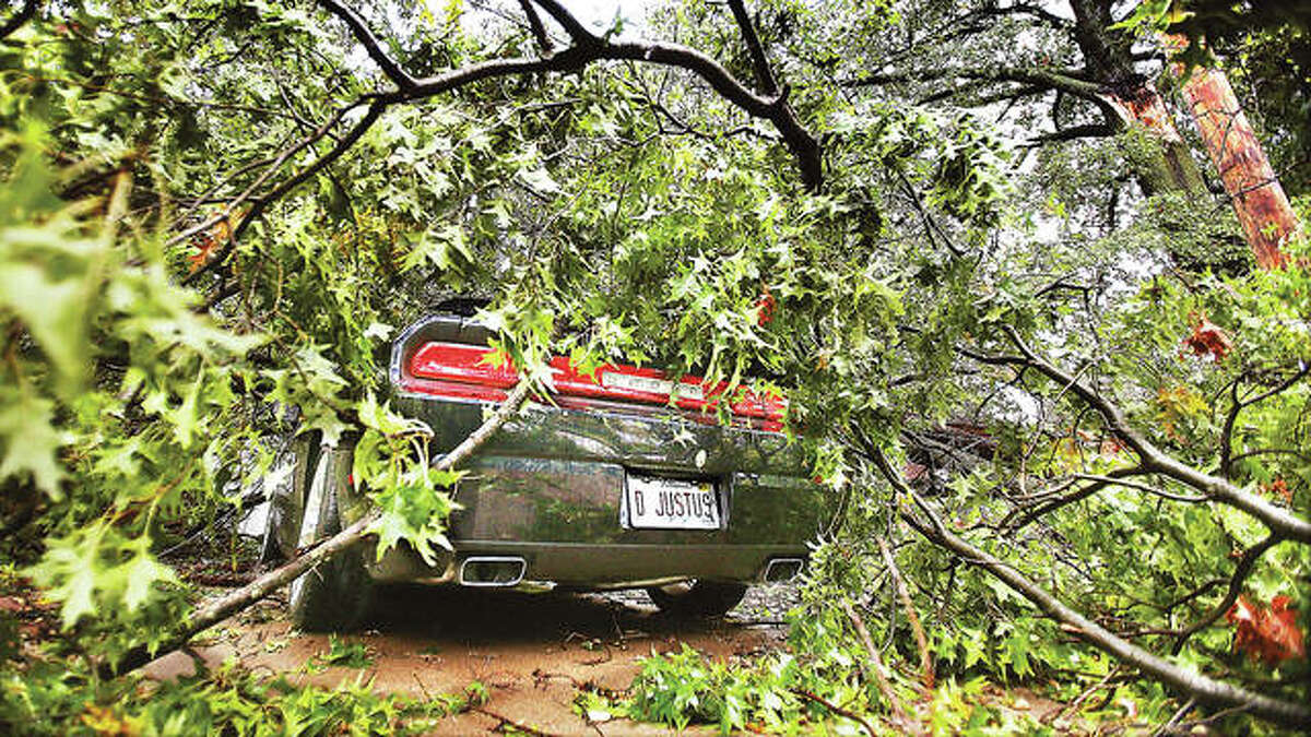 There was no justice in what happened to the 2012 Dodge Challenger of Debbie Justus in the storm late Monday night when part of a tree fell on her car in the driveway at the corner of Worden and Edwards streets in Alton. The large branch crushed part of the car’s top, smashed through the windshield and rammed into her dashboard, as well as causing minor damage to the house’s roof.
