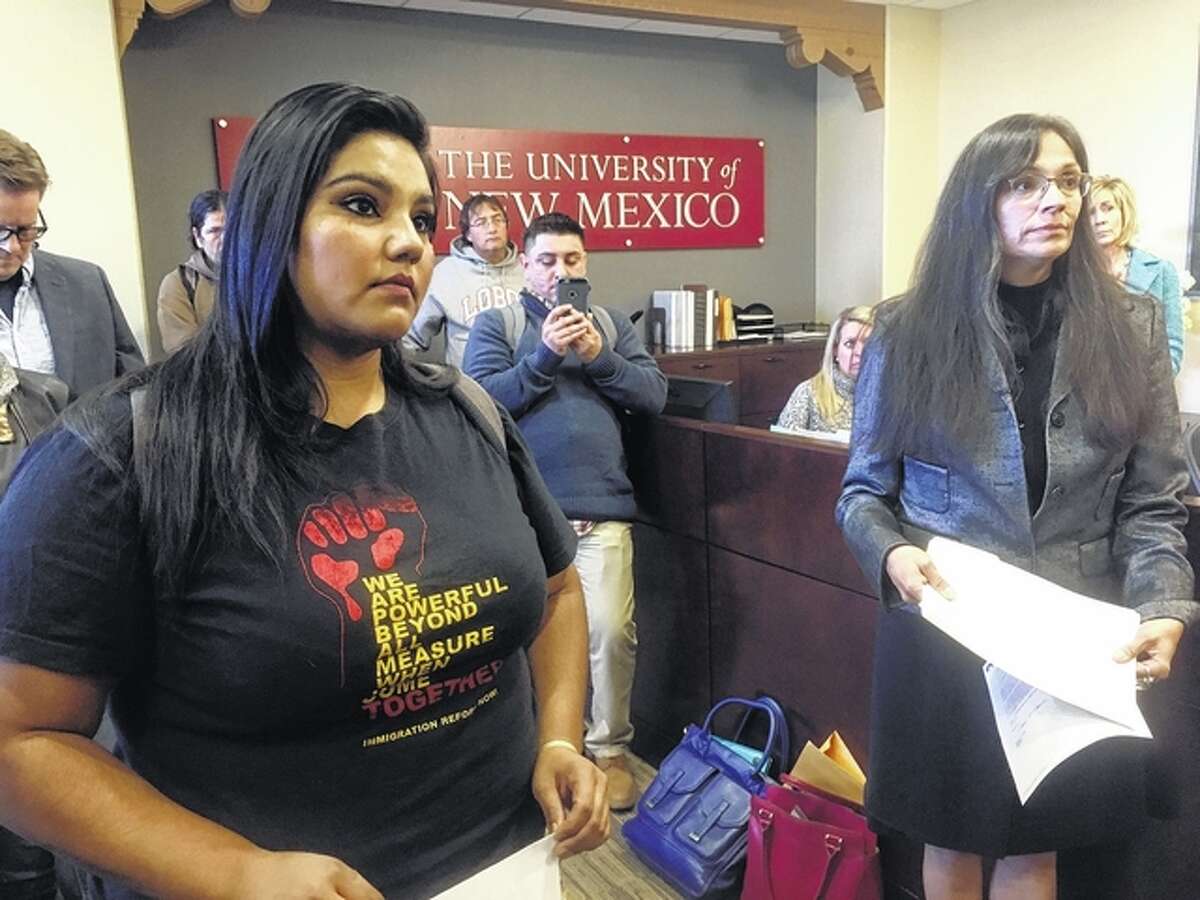 University of New Mexico student LuzHilda Campos, left, and Chicano studies professor Irene Vasquez, right, present a letter with hundreds of signatures on Friday to school president Bob Frank asking him to declare the campus a “sanctuary university,” in Albuquerque, New Mexico. A group of professors at the largest university in the nation’s most Hispanic state are asking for more protection of immigrant students following the election of Republican Donald Trump. Russell Contreras | AP Photo