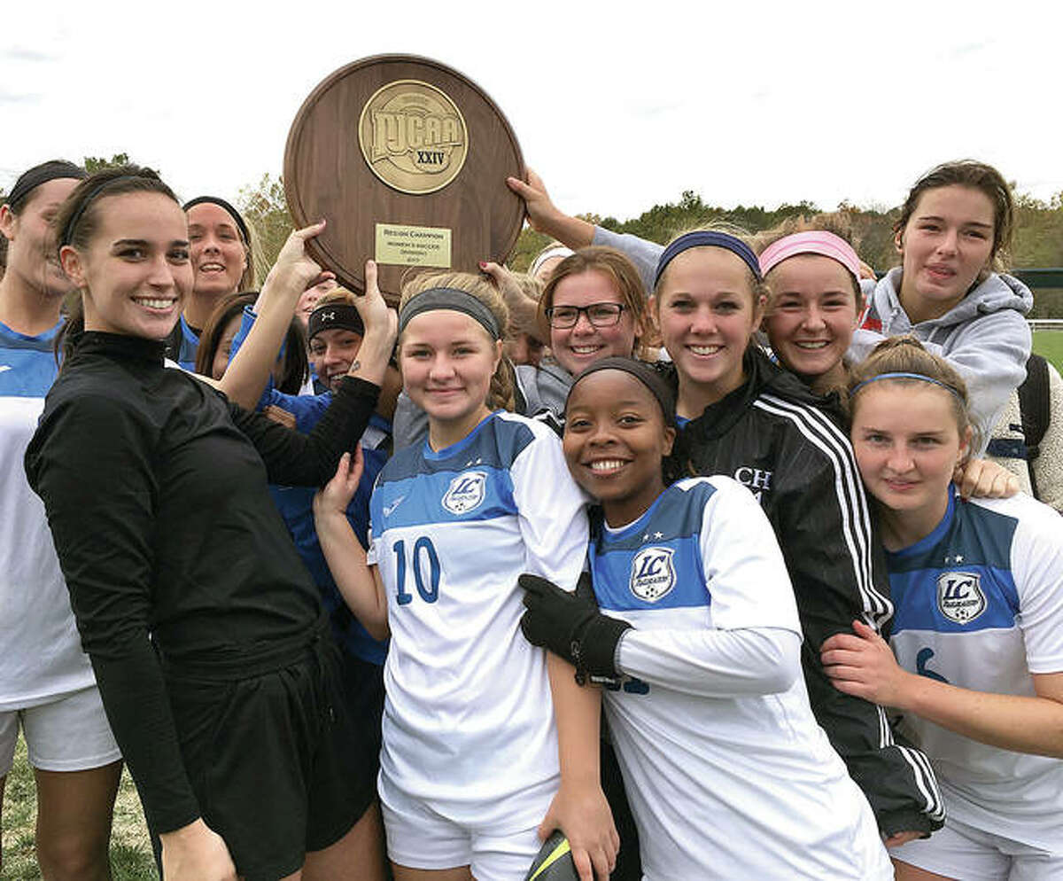Members of the Lewis and Clark Community College women’s soccer team celebrate with the NJCAA Region 24 championship plaque Sunday afternoon at LCCC. The Trailblazers rallied to defeat rival SWIC 3-1.