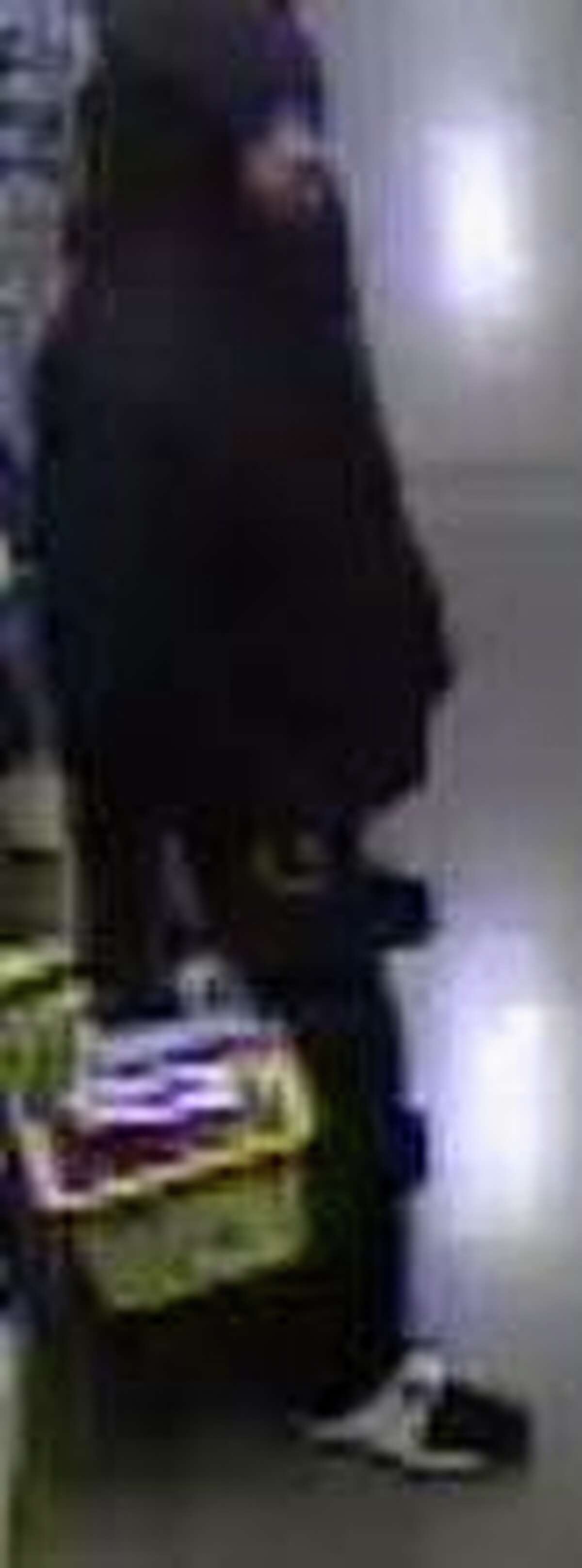 Surveillance photos of the armed robbery suspect.