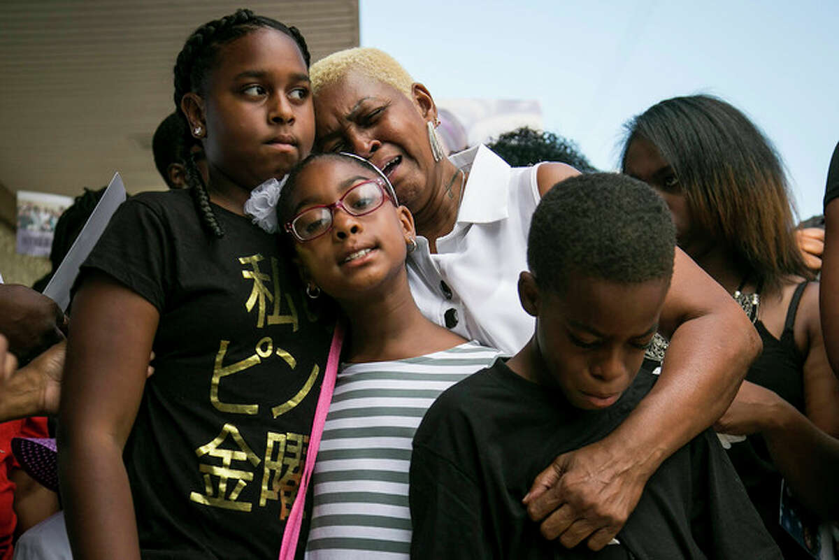 Ashlee Rezin | Chicago Sun-Times (AP) Diann Aldridge hugs her grandchildren, Summer (left), Sincere (right) and Shavae during a vigil for their mother, Nykea Aldridge, in Chicago. Nykea Aldridge, a mother and the cousin of NBA star Dwyane Wade, was shot and killed while pushing her baby in a stroller. Chicago’s continuing gun violence was chosen by The Associated Press as one of the top news stories in Illinois this year.
