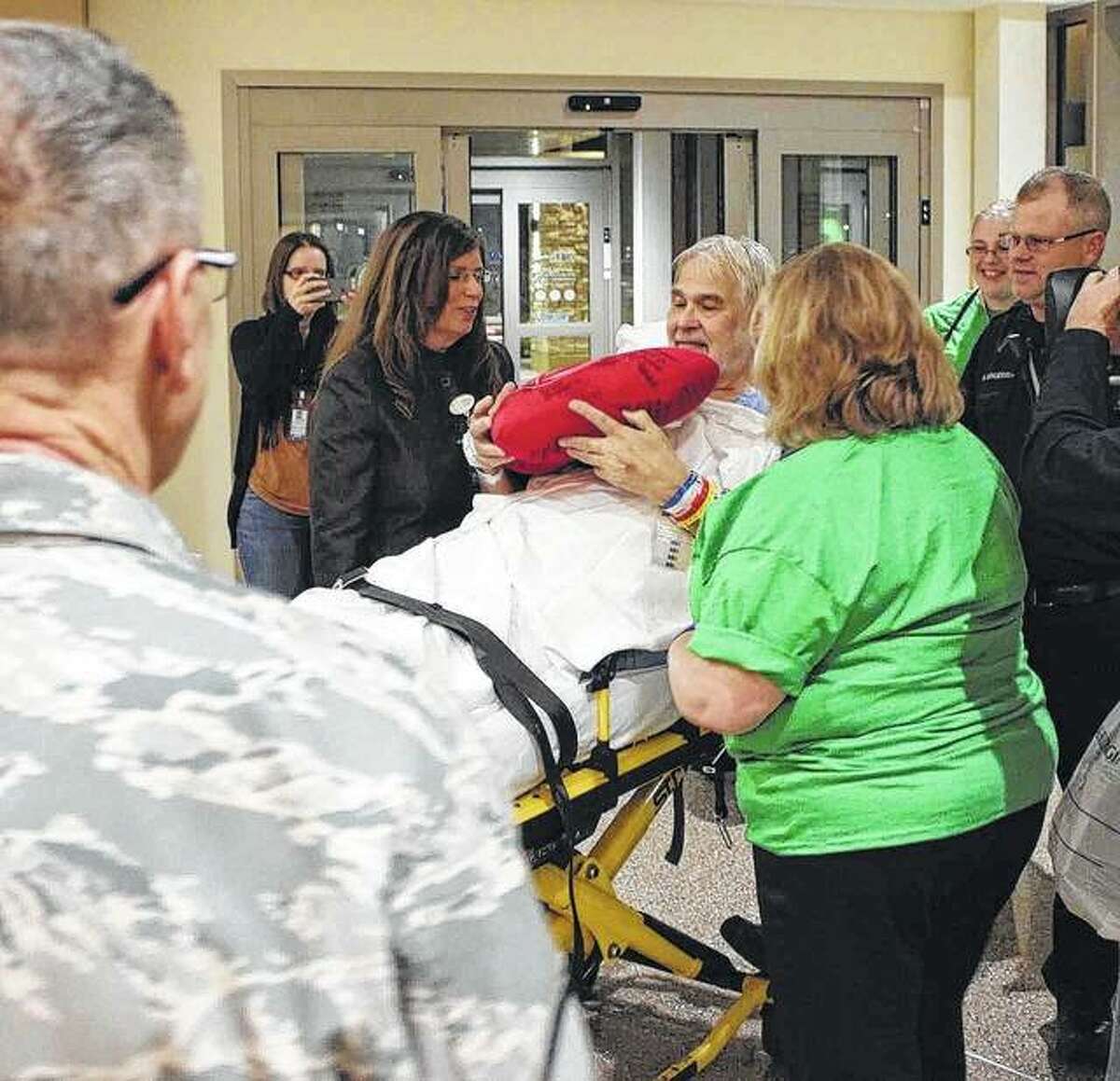 Daniel Thelen of Belleville was pleased to be the first patient admitted to the new HSHS St. Elizabeth’s Hospital in O’Fallon. He is surrounded by HSHS St. Elizabeth’s clinical staff and Scott Air Force Base personnel assisting with the move.
